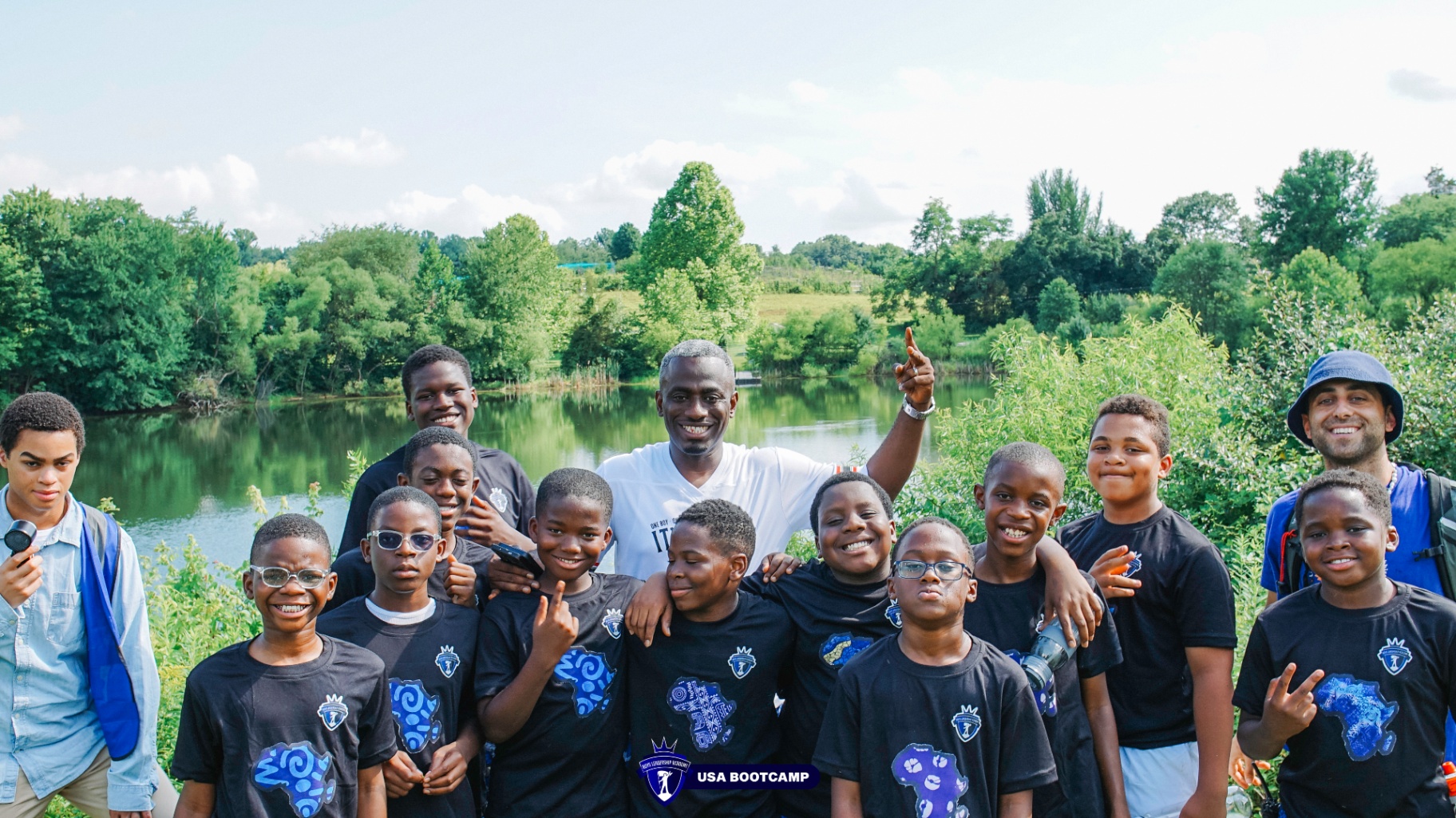 Boys and mentors gathered by the lake for a group photo.